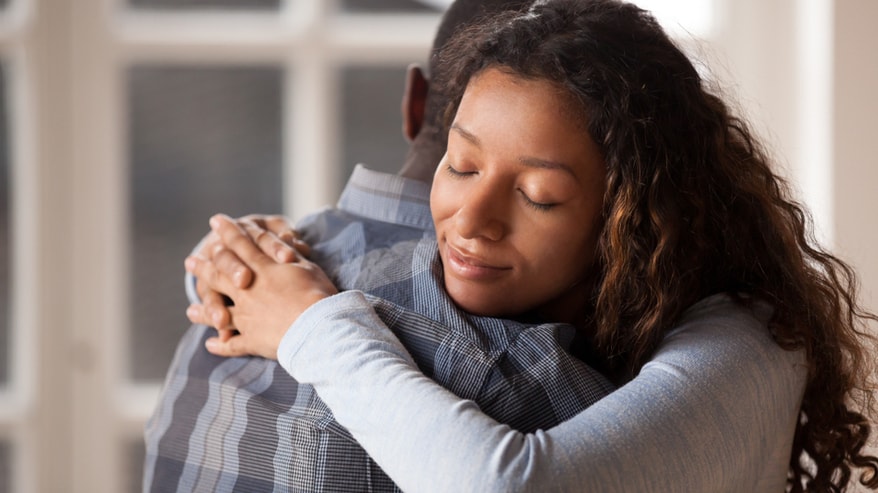 Daughter hugging her father after being reunited