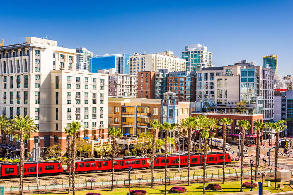 Downtown san diego with red train and palm trees