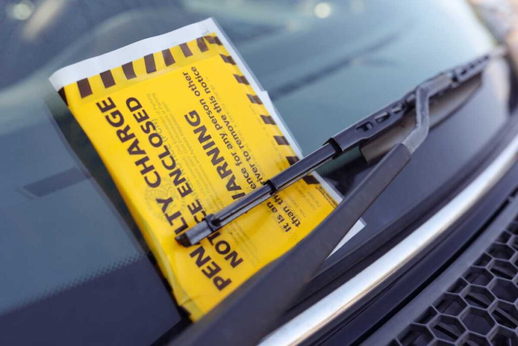 A frustrated woman discovers a parking ticket on her car