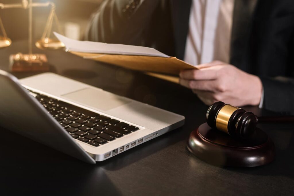 A lawyer with a laptop and documents