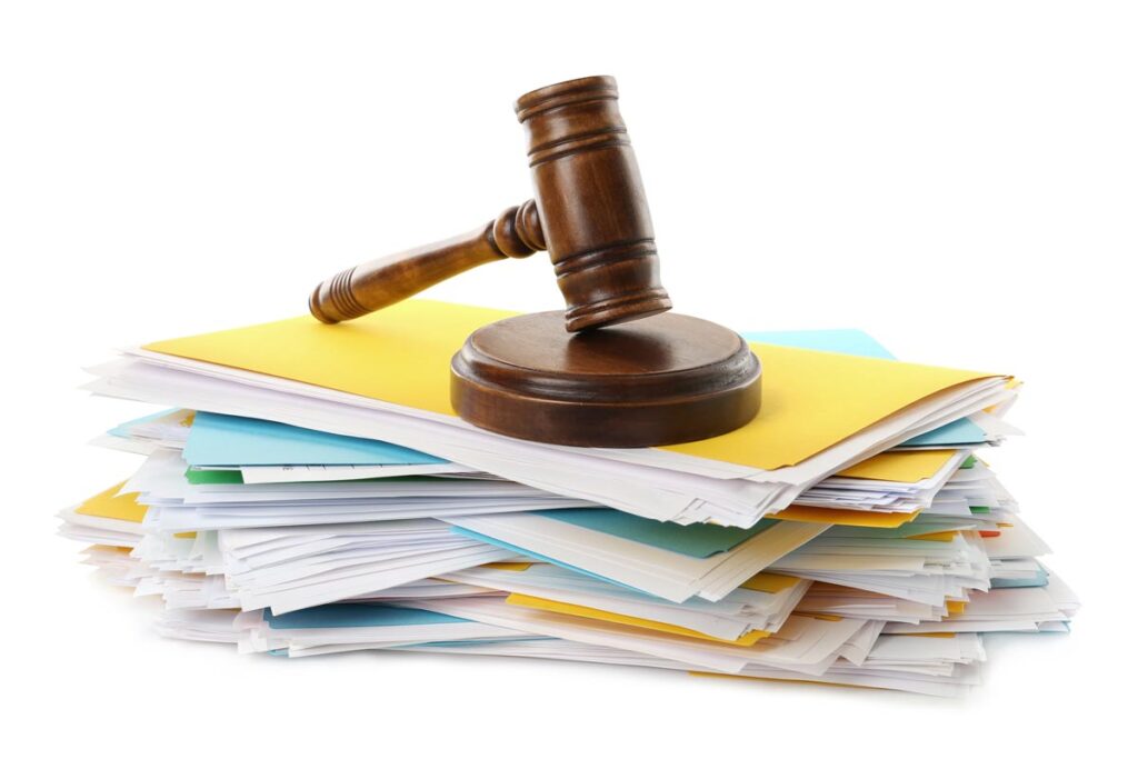 A stack of paperwork under a gavel