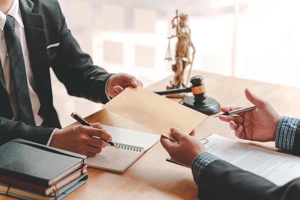 Attorney and client sitting across the desk from eachother