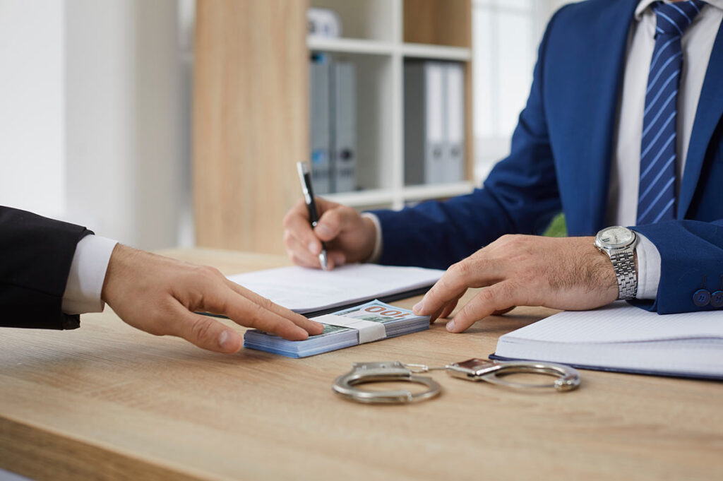 Man in suit talking and signing paperwork