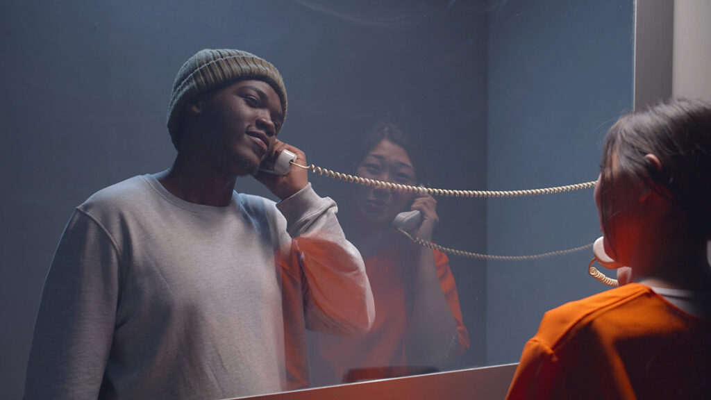 Visiting an inmate behind glass.