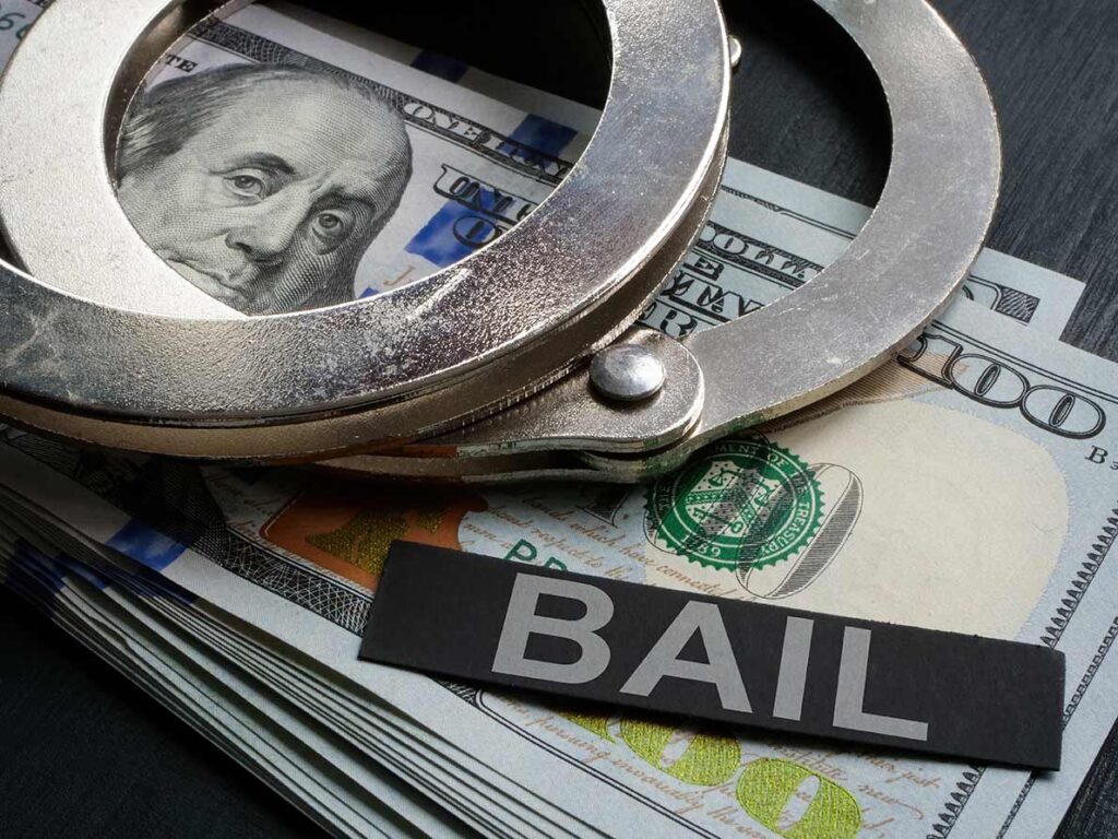 Handcuffs on top of hundred-dollar bills