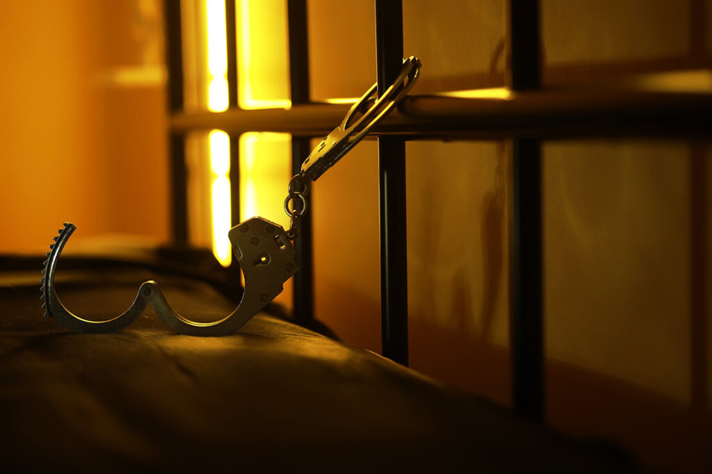 Jail bars with hand cuffs