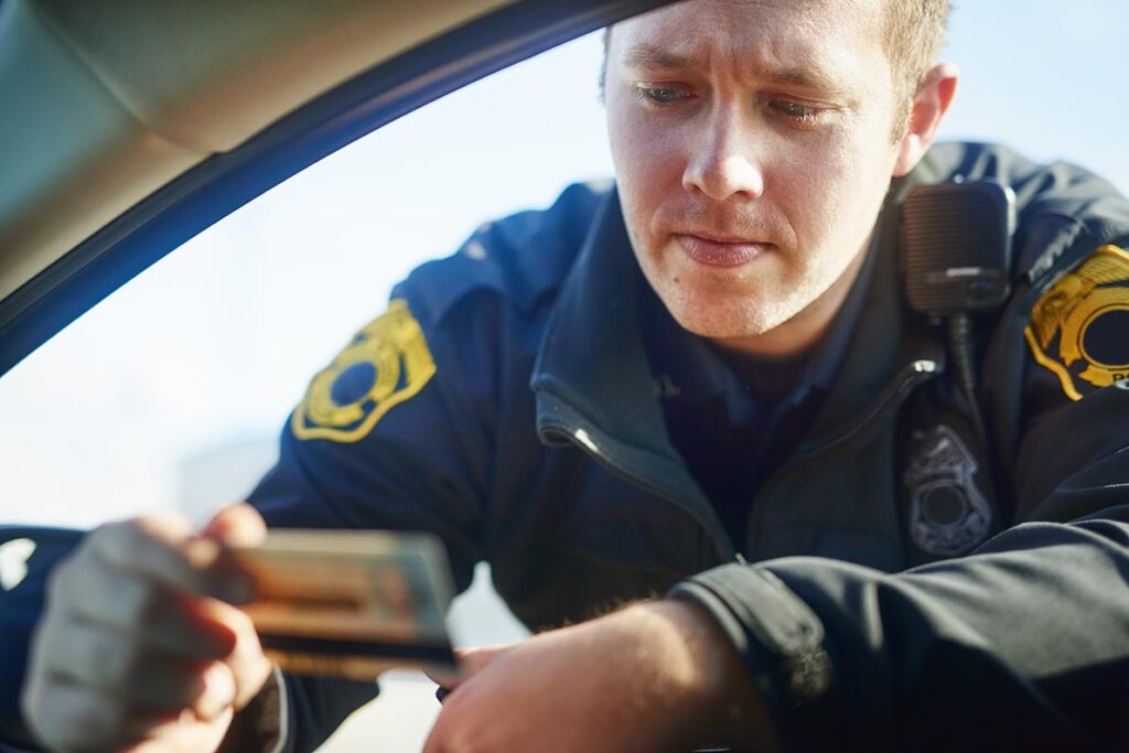 A police officer checking a driver’s ID.