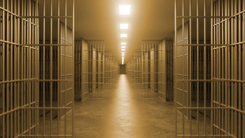 Looking down a corridor of jail cells.